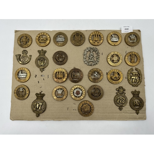 2318 - A collection of military cap badges