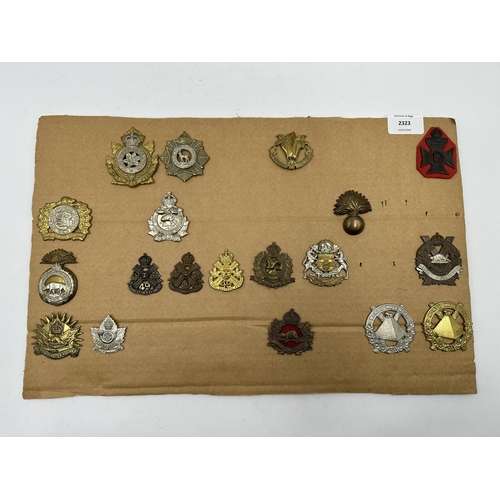 2323 - A collection of military cap badges