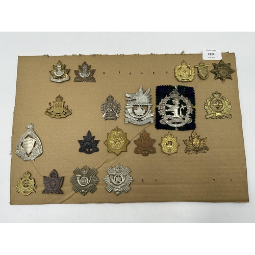 2324 - A collection of military cap badges