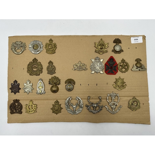 2326 - A collection of military cap badges