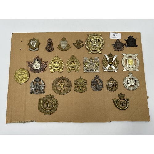 2327 - A collection of military cap badges