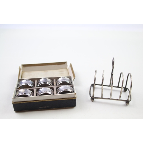 2269 - Seven pieces of silver, one .925 toast rack and a boxed set of six .800 napkin rings - approx. gross... 