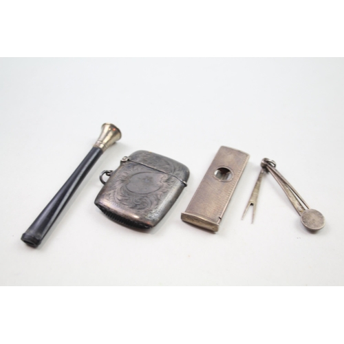 2284 - Four .925 sterling silver tobacciana items to include vesta case, cigar cutter etc. - approx. gross ... 