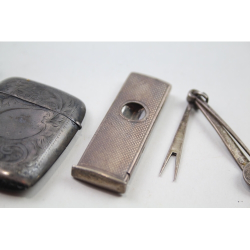 2284 - Four .925 sterling silver tobacciana items to include vesta case, cigar cutter etc. - approx. gross ... 