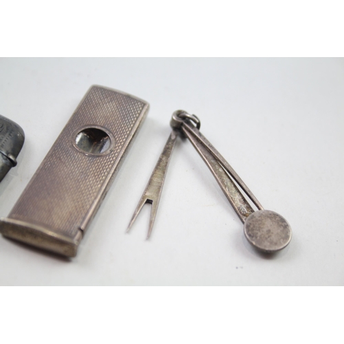 2284 - Four .925 sterling silver tobacciana items to include vesta case, cigar cutter etc. - approx. gross ... 