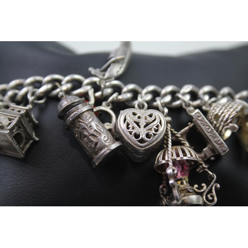 2468 - A silver charm bracelet with assorted charms - approx. gross weight 99g