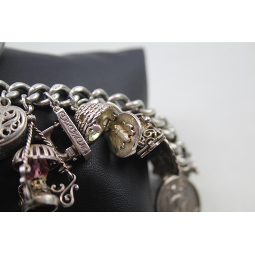 2468 - A silver charm bracelet with assorted charms - approx. gross weight 99g