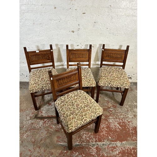 130 - Four carved oak and floral fabric upholstered dining chairs