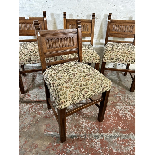 130 - Four carved oak and floral fabric upholstered dining chairs
