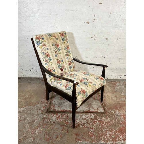 131 - A mid 20th century beech and fabric upholstered armchair