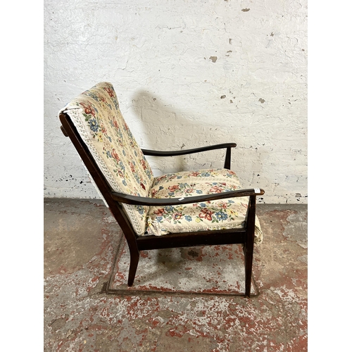 131 - A mid 20th century beech and fabric upholstered armchair