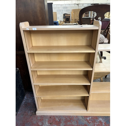 169 - A modern beech three section graduating bookcase - approx. 137cm high x 238cm wide x 23cm deep