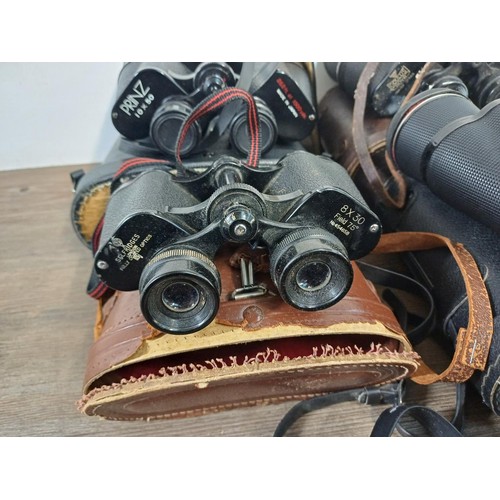 586 - Seven pairs of binoculars to include Selfridges 8 x 30, Wray Wrayvu 8 x 30, Tasco 12 x 50, Oculus 20... 