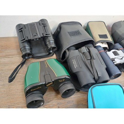 591 - A collection of pocket binoculars to include Summit, Executive etc.