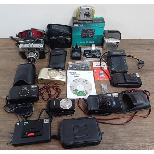 593 - A collection of cameras to include boxed Fujifilm JX530 14mp compact digital with accessories, charg... 