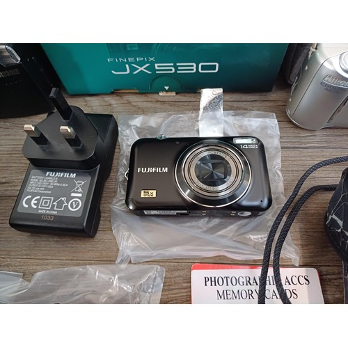 593 - A collection of cameras to include boxed Fujifilm JX530 14mp compact digital with accessories, charg... 