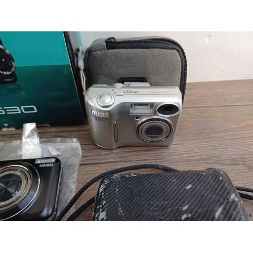 593 - A collection of cameras to include boxed Fujifilm JX530 14mp compact digital with accessories, charg... 