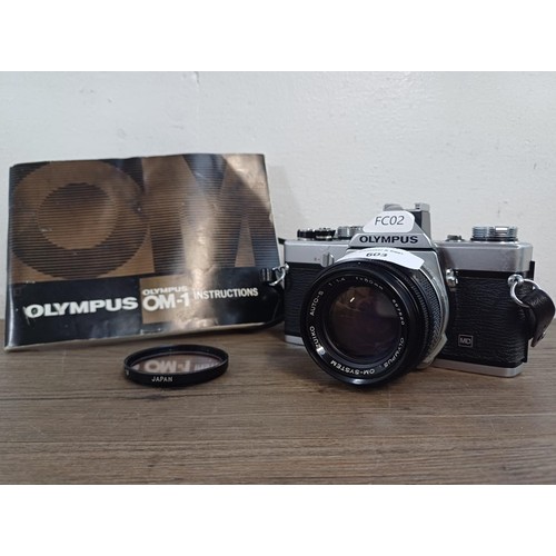 603 - An Olympus OM-1 35mm SLR camera fitted with G.Zuiko f=50mm 1:1.4 Auto-S lens with instruction manual