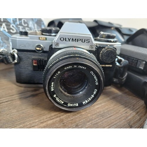 605 - A collection of Olympus items to include two OM10 35mm SLR cameras, nine cased T20 flashes, two OM W... 