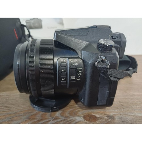 614 - A cased Panasonic Lumix FZ2000 20.1mp digital photo and 4K video bridge camera fitted with Leica DC ... 