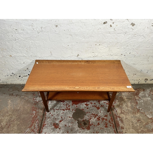 100 - A mid 20th century teak rectangular two tier coffee table