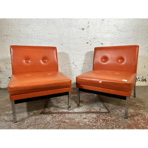 101 - A pair of mid 20th century red vinyl and chrome plated lounge chairs