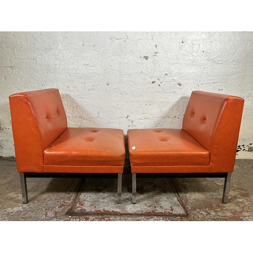 101 - A pair of mid 20th century red vinyl and chrome plated lounge chairs