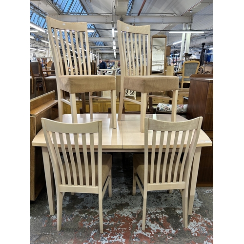 117 - A modern painted beech extending dining table and four chairs