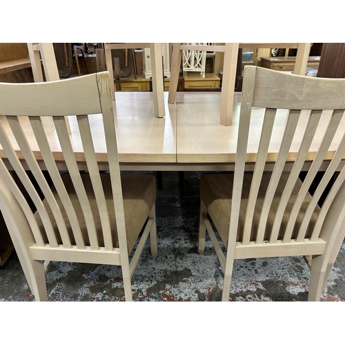 117 - A modern painted beech extending dining table and four chairs