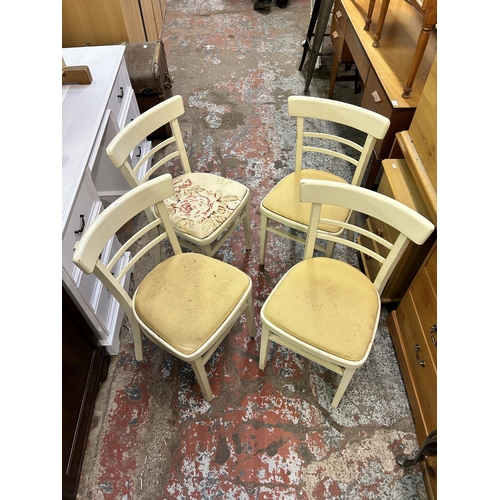 118A - A set of four mid 20th century white painted dining chairs