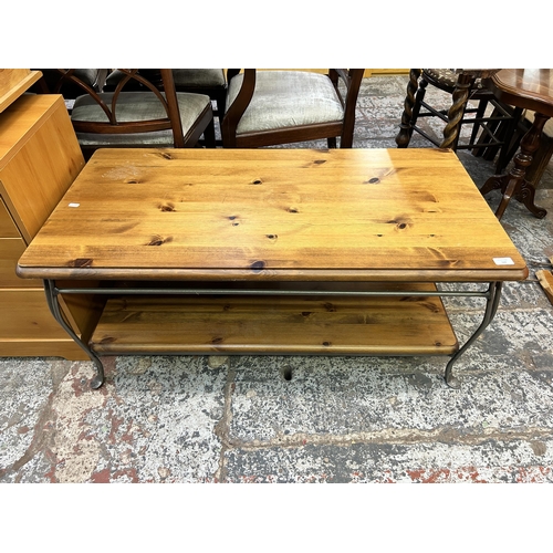 120 - A pine and wrought iron rectangular two tier coffee table