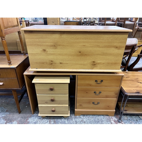 121 - Three pieces of modern pine effect furniture, blanket box, dressing table and bedside chest of drawe... 