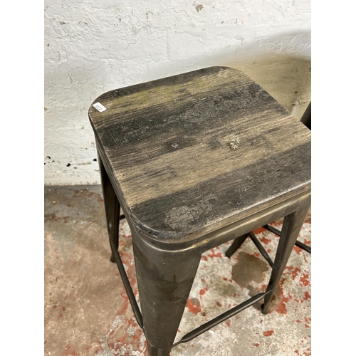 124 - A pair of industrial style oak and metal barstools - approx. 77cm high