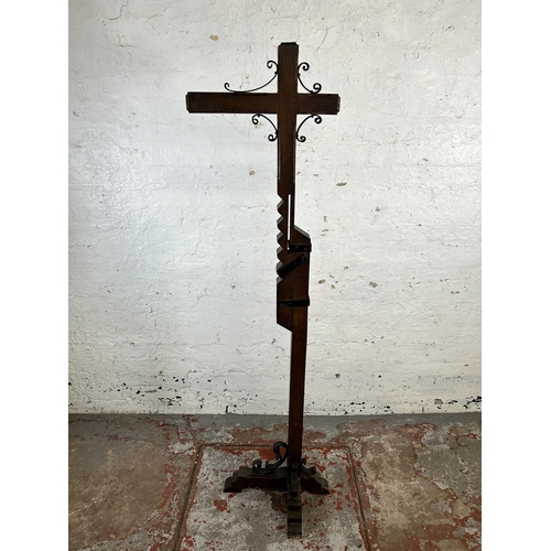 134 - An Arts and Crafts style oak and wrought metal standard lamp - approx. 166cm high
