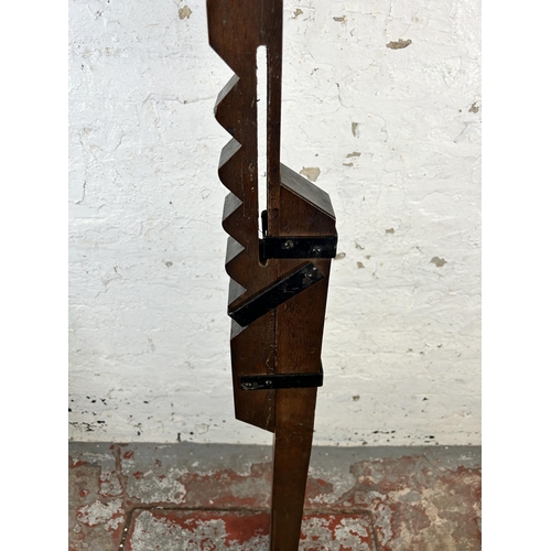 134 - An Arts and Crafts style oak and wrought metal standard lamp - approx. 166cm high