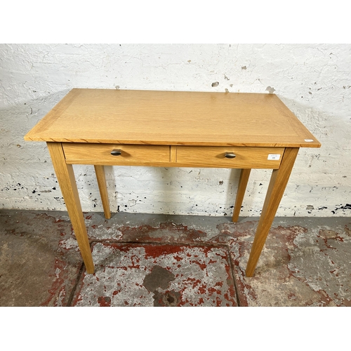 141 - A modern oak two drawer dressing table - approx. 75cm high x 88cm wide x 46cm deep