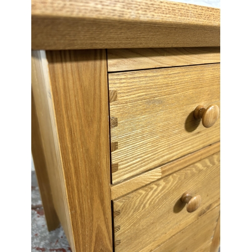 156 - A modern oak bedside chest of drawers