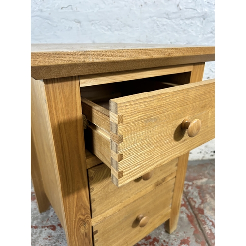 156 - A modern oak bedside chest of drawers