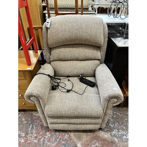 18 - A modern fabric upholstered electric reclining armchair with power supply