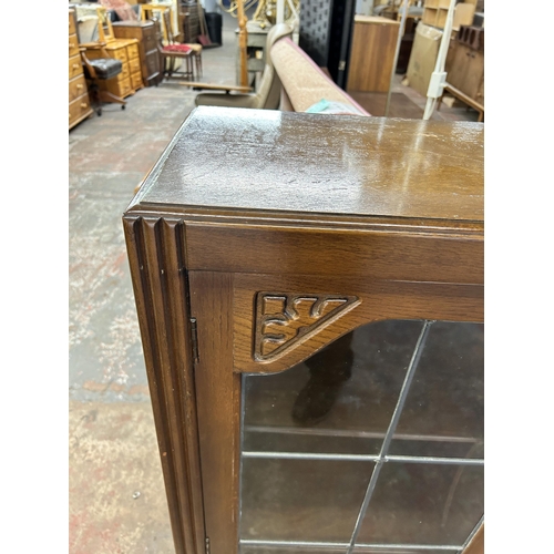 199 - A Jentique carved oak bookcase with two lead glazed doors - approx. 107cm high x 91cm wide x 31cm de... 