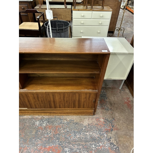 202 - A mid 20th century Herbert E. Gibbs teak bookcase - approx. 84cm high x 152cm wide x 24cm deep