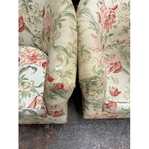 209 - A pair of Victorian style floral fabric upholstered armchairs with turned wooden supports and brass ... 