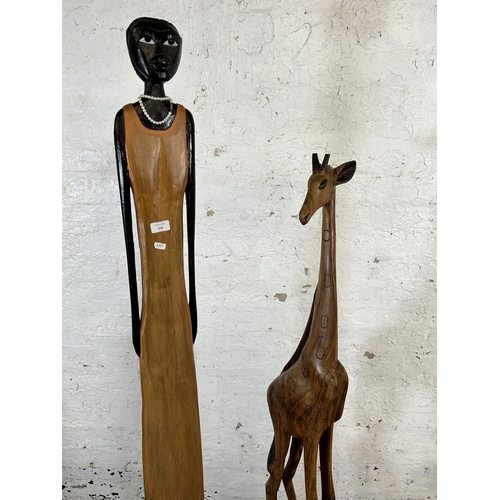 218 - Two carved hardwood statues, one giraffe - approx. 150cm high and one lady - approx. 173cm high