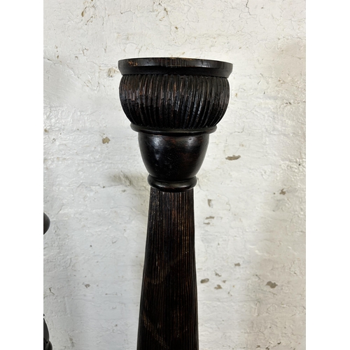 220 - Two African carved hardwood torchères - largest approx. 156cm high