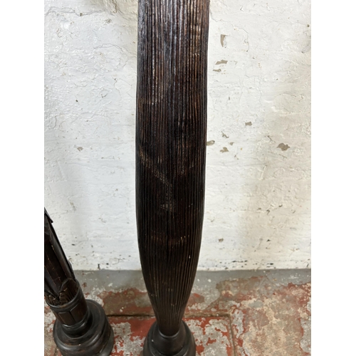 220 - Two African carved hardwood torchères - largest approx. 156cm high