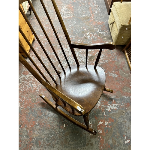 221 - An elm and beech spindle back farmhouse rocking chair