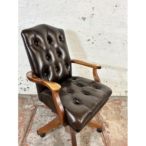 232 - A Ducal pine and brown leather button back swivel office desk chair