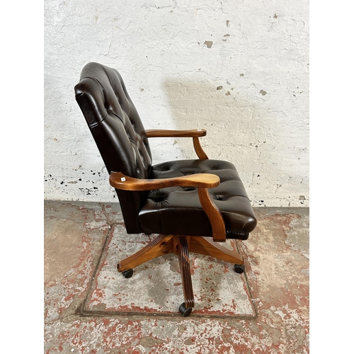 232 - A Ducal pine and brown leather button back swivel office desk chair