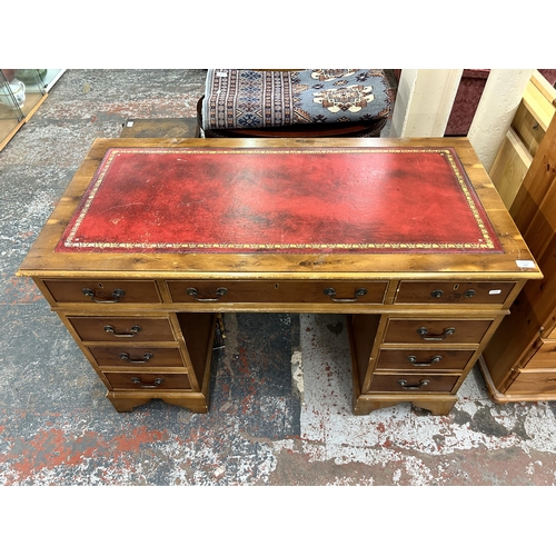 235 - A yew wood and red leather pedestal writing desk - approx. 78cm high x 122cm wide x 60cm deep