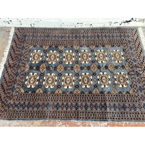 237 - A 20th century blue machine woven rug - approx. 180cm x 126cm